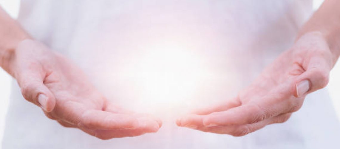 Close up horizontal image of distance healing hands of therapist at Reiki healing treatment. Alternative therapy concept